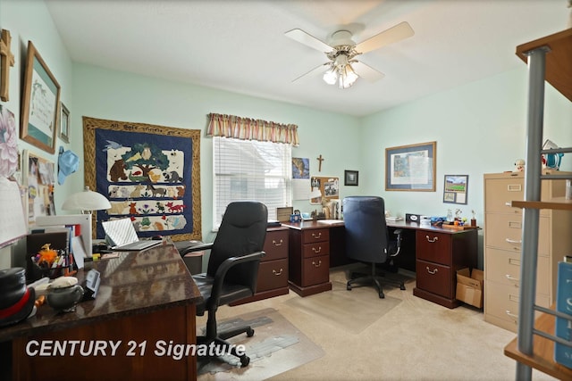 office space with light carpet and a ceiling fan