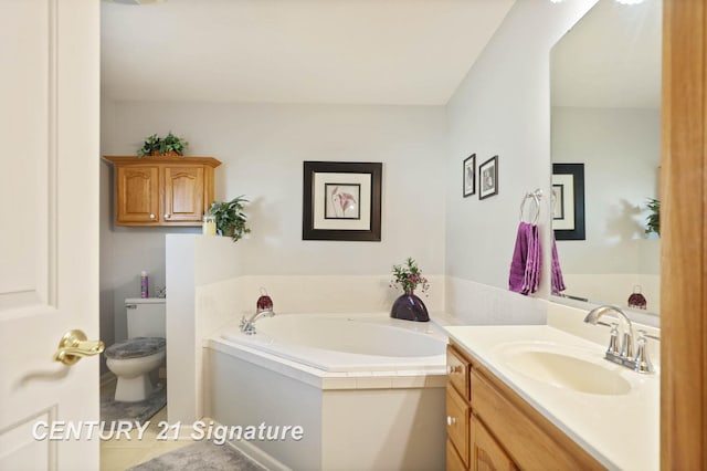 bathroom featuring toilet, tile patterned floors, a garden tub, and vanity