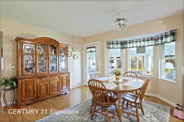 dining space with light wood-style floors, ceiling fan, and baseboards