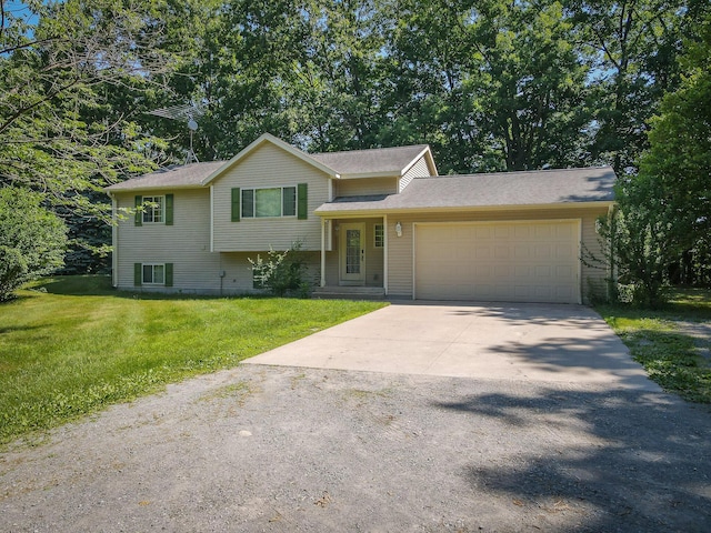 8594 S Felch Ave, Newaygo, MI 49337 - tri-level home with a garage, concrete driveway, and a front lawn