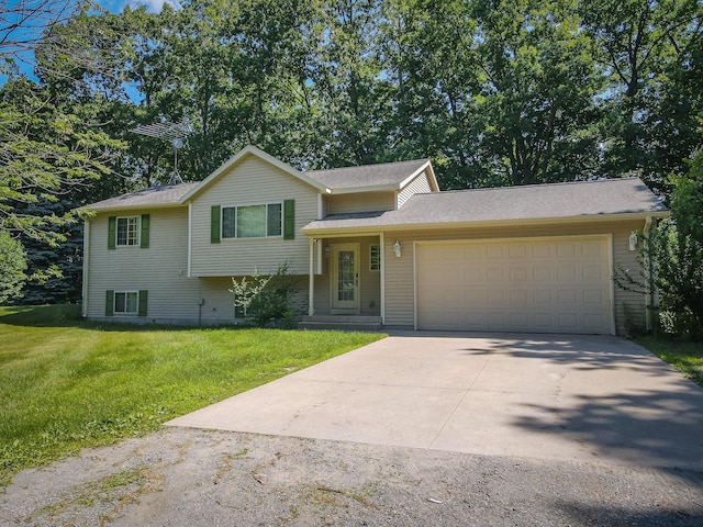 8594 S Felch Ave, Newaygo, MI 49337 - tri-level home with driveway, a garage, and a front yard