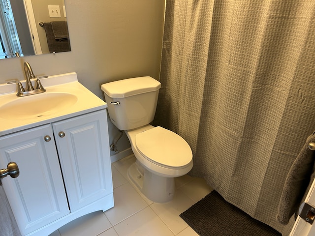 bathroom featuring toilet, tile patterned flooring, and vanity