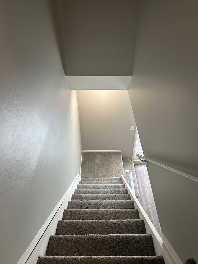 stairs with baseboards and carpet