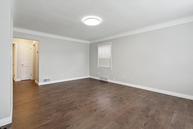 4677 Chatsworth St, Detroit, MI 48224 - empty room featuring visible vents, dark wood-style flooring, and baseboards