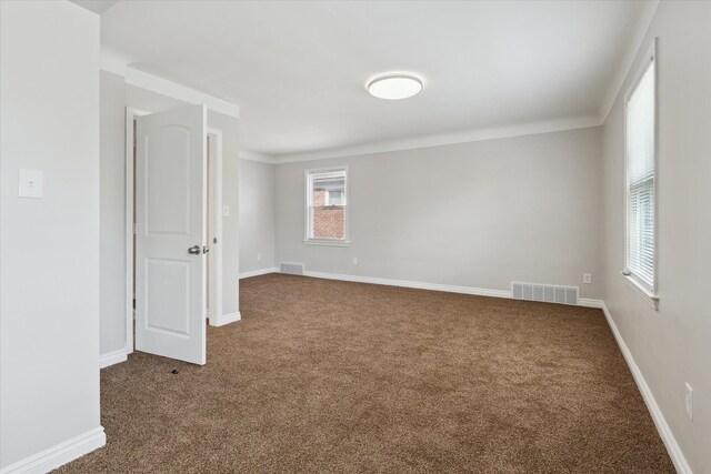 4677 Chatsworth St, Detroit, MI 48224 - spare room with crown molding, carpet floors, and visible vents