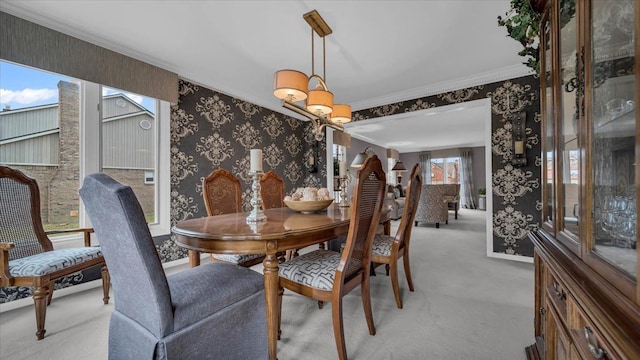 dining space featuring light carpet, baseboards, ornamental molding, and wallpapered walls