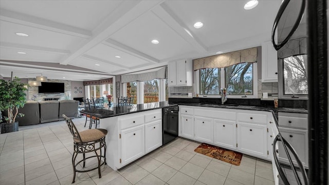 kitchen with decorative backsplash, open floor plan, dishwasher, a peninsula, and white cabinetry
