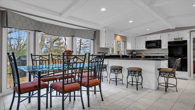 dining room featuring lofted ceiling with beams, recessed lighting, and light tile patterned floors