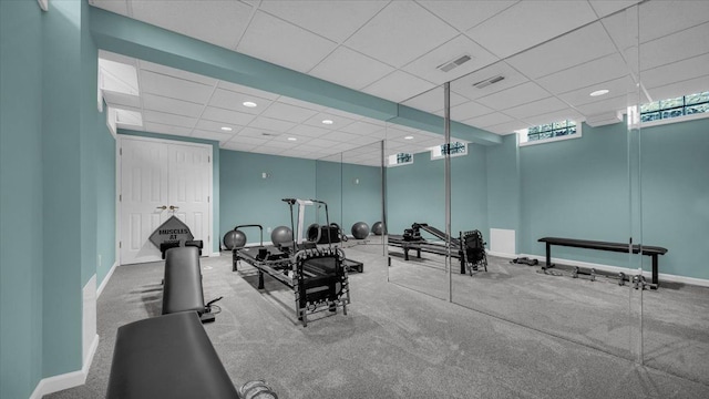 workout area featuring recessed lighting, visible vents, a drop ceiling, and baseboards