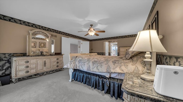 carpeted bedroom featuring visible vents and ceiling fan
