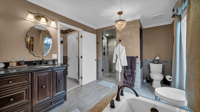 bathroom featuring a shower stall, crown molding, a bath, vanity, and visible vents