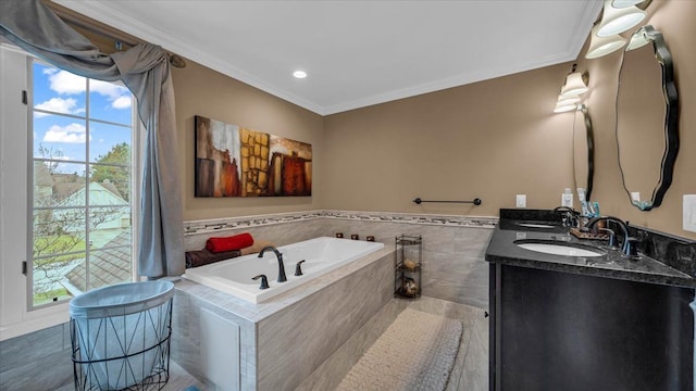 full bath featuring a garden tub, a healthy amount of sunlight, a sink, and crown molding