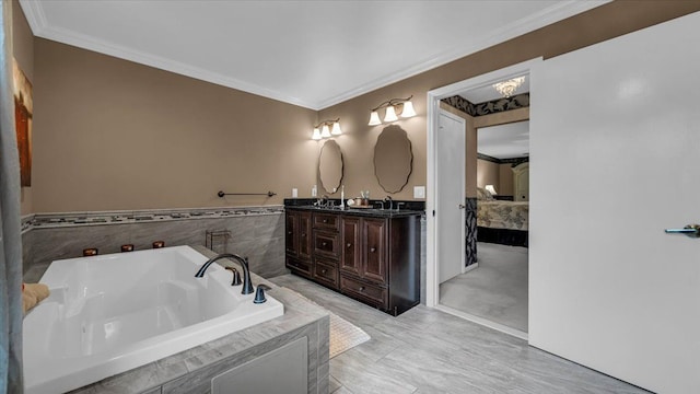 bathroom featuring a bath, a sink, double vanity, and crown molding