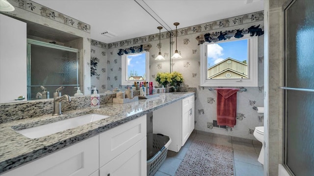 full bath with a shower stall, tile patterned floors, vanity, and plenty of natural light