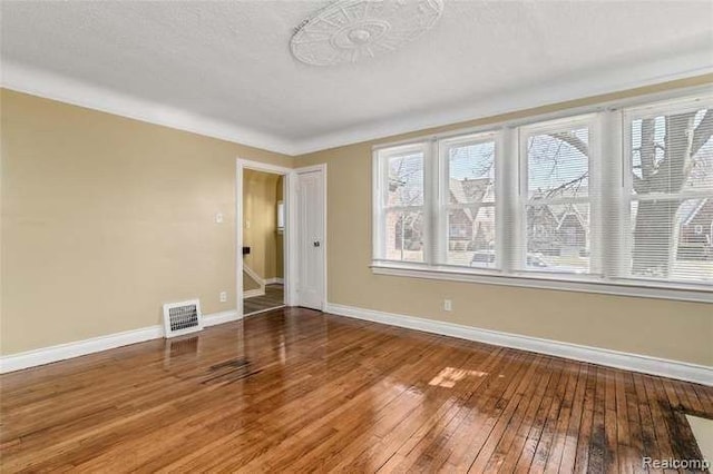 6127 Grayton St, Detroit, MI 48224 - spare room featuring stairs, visible vents, baseboards, and hardwood / wood-style floors
