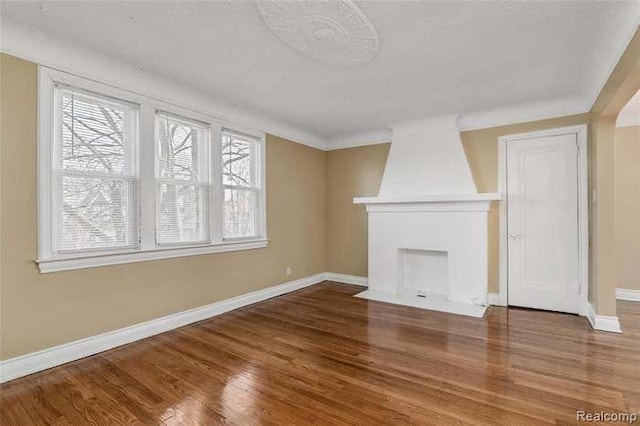6127 Grayton St, Detroit, MI 48224 - unfurnished living room with wood finished floors, a fireplace, and baseboards