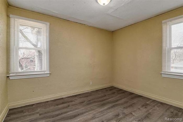 6127 Grayton St, Detroit, MI 48224 - unfurnished room featuring wood finished floors, baseboards, and a wealth of natural light