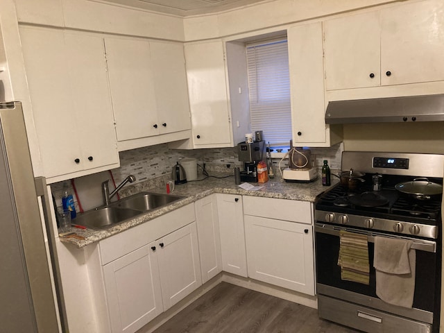 6127 Grayton St, Detroit, MI 48224 - kitchen with dark wood-style flooring, white cabinetry, under cabinet range hood, stainless steel gas stove, and a sink