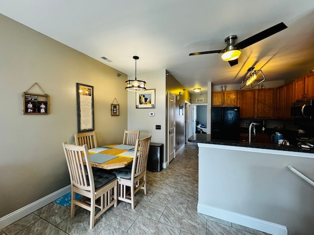207 Legato Dr, Walled Lake, MI 48390 - kitchen with stainless steel microwave, freestanding refrigerator, a sink, ceiling fan, and a peninsula