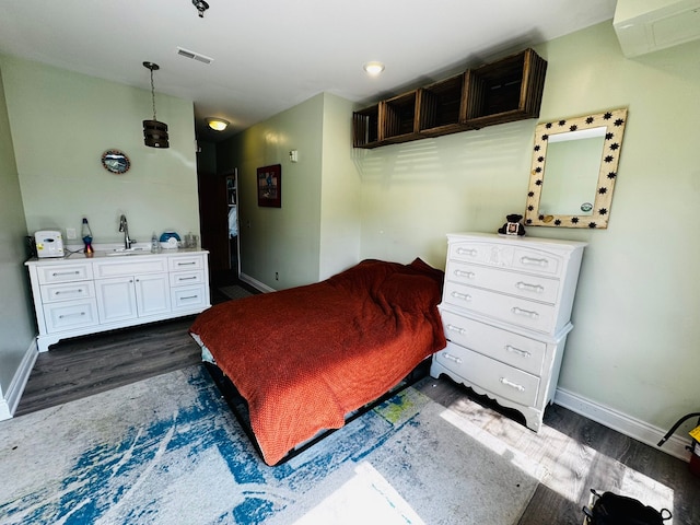 207 Legato Dr, Walled Lake, MI 48390 - bedroom with dark wood-style floors, an AC wall unit, and baseboards