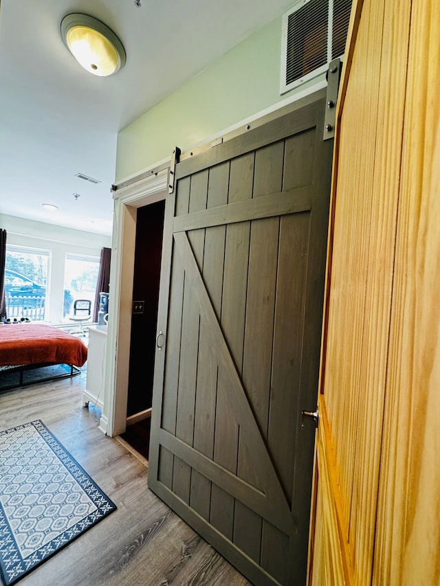 207 Legato Dr, Walled Lake, MI 48390 - hall featuring a barn door and light wood-style floors