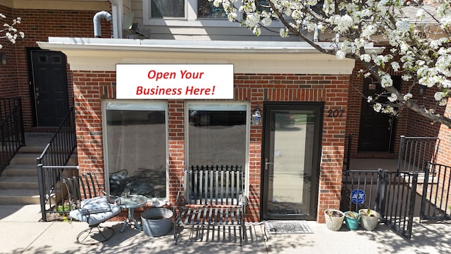 207 Legato Dr, Walled Lake, MI 48390 - doorway to property featuring brick siding