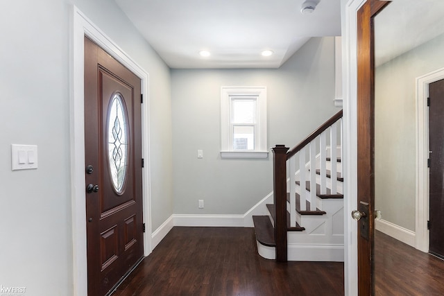 entrance foyer with baseboards, wood finished floors, and stairs