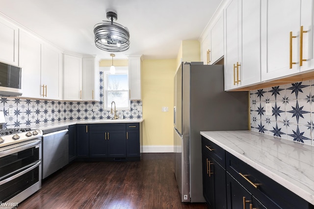 kitchen featuring tasteful backsplash, white cabinetry, and stainless steel appliances