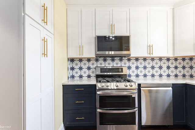kitchen featuring white cabinets, decorative backsplash, and appliances with stainless steel finishes