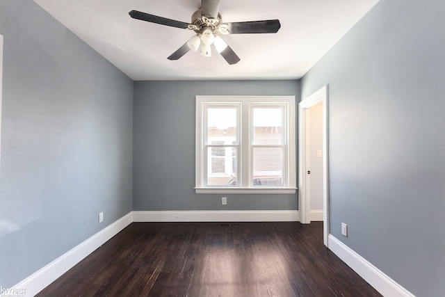 unfurnished room featuring dark wood-type flooring, baseboards, and a ceiling fan
