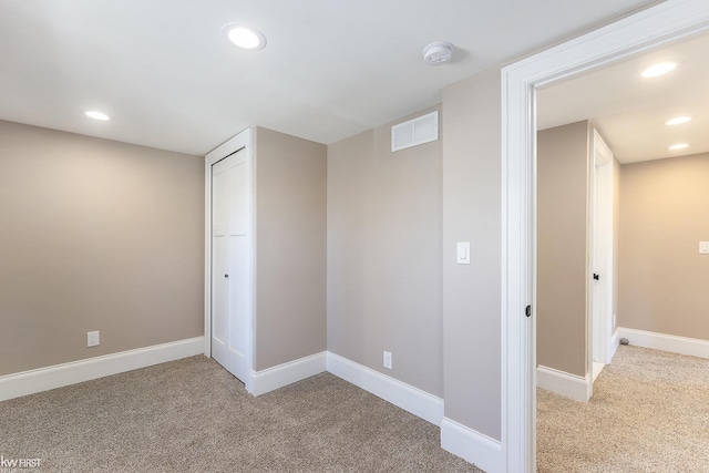 below grade area with recessed lighting, carpet flooring, and visible vents