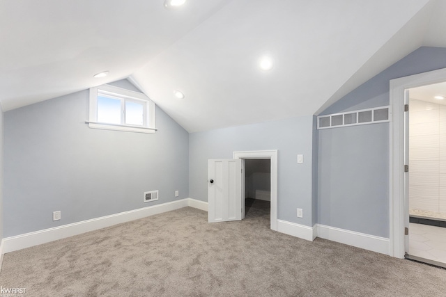additional living space with visible vents, carpet, vaulted ceiling, and recessed lighting