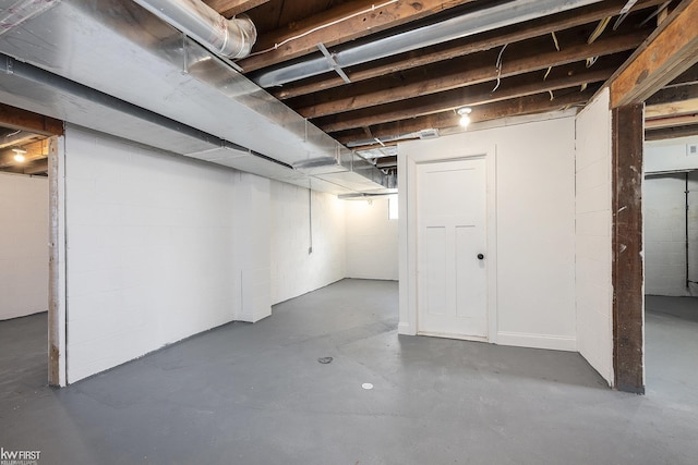 unfinished basement with concrete block wall