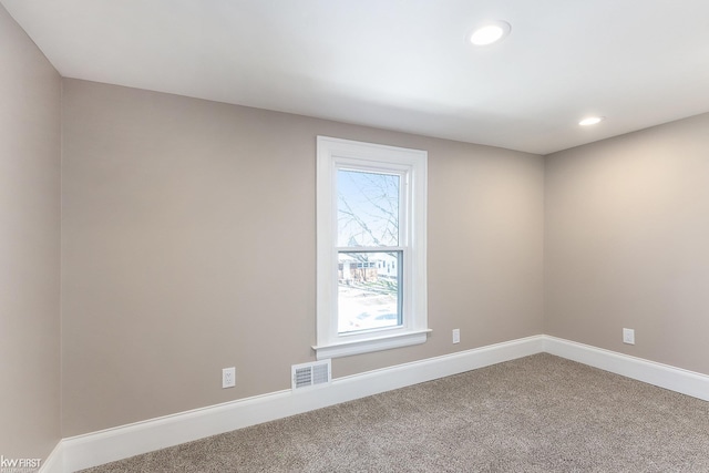carpeted empty room with recessed lighting, visible vents, and baseboards