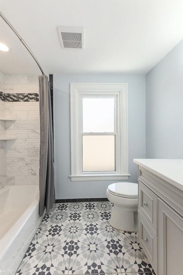 bathroom with visible vents, toilet, shower / tub combo, and vanity