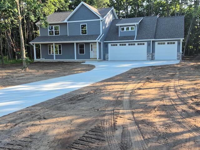 2035 Dakota Trl, Hastings, MI 49058 - view of front of home with concrete driveway, a garage, and a shingled roof