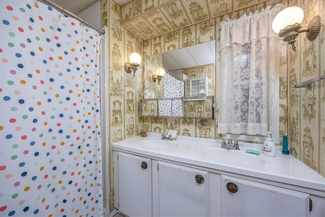 6313 Fairlane Dr, Lake City, MI 49651 - full bath featuring a shower with shower curtain, wallpapered walls, double vanity, and a sink