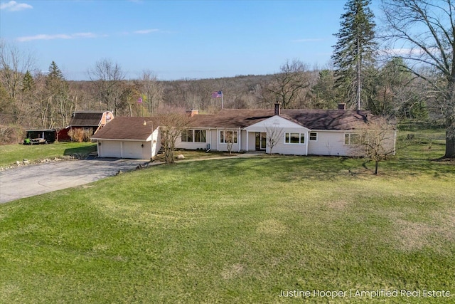 1220 W Green St, Hastings, MI 49058 - ranch-style home featuring a garage, aphalt driveway, and a front lawn