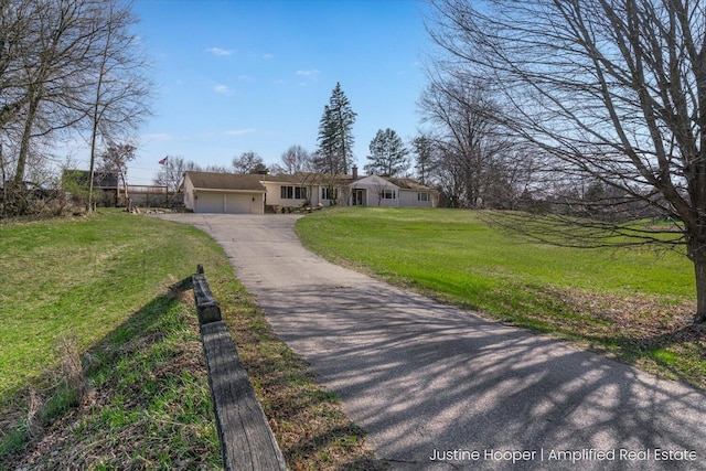 1220 W Green St, Hastings, MI 49058 - view of front of home featuring driveway, an attached garage, and a front lawn