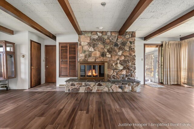 1220 W Green St, Hastings, MI 49058 - unfurnished living room with wood finished floors, beamed ceiling, and a fireplace
