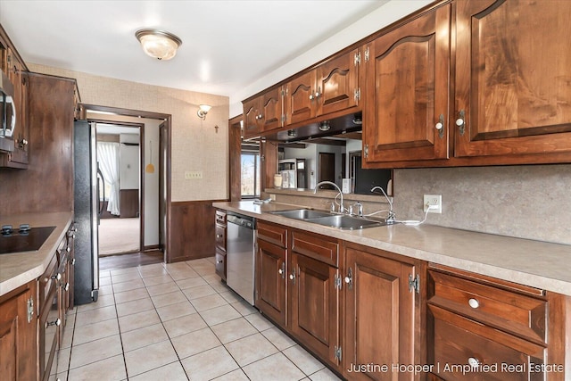 1220 W Green St, Hastings, MI 49058 - kitchen with light countertops, light tile patterned floors, a sink, and black appliances