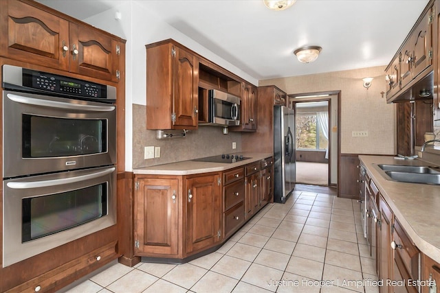 1220 W Green St, Hastings, MI 49058 - kitchen featuring a sink, light tile patterned floors, light countertops, and appliances with stainless steel finishes