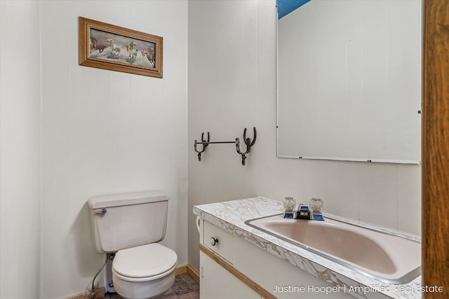 1220 W Green St, Hastings, MI 49058 - bathroom with toilet, vanity, and baseboards