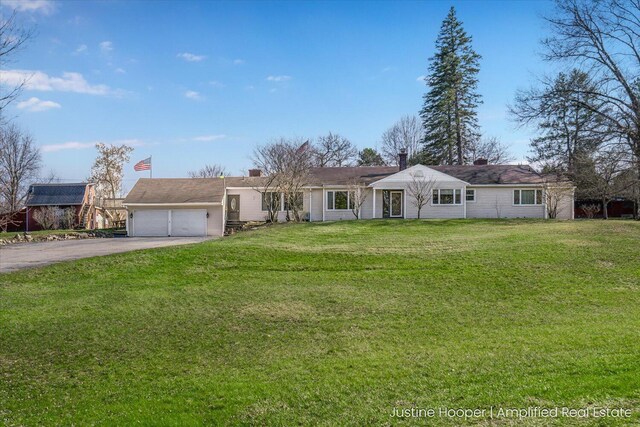 1220 W Green St, Hastings, MI 49058 - ranch-style house with a garage, aphalt driveway, and a front lawn
