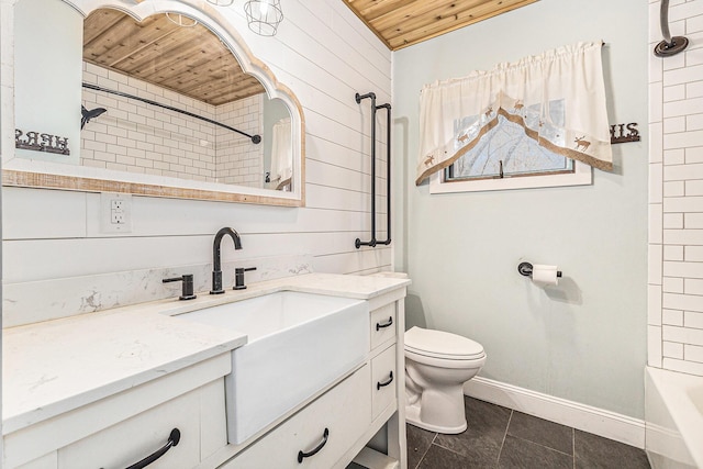 bathroom featuring vanity, baseboards, tile patterned floors, toilet, and wooden ceiling