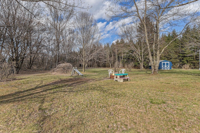 view of yard with an outbuilding and a shed