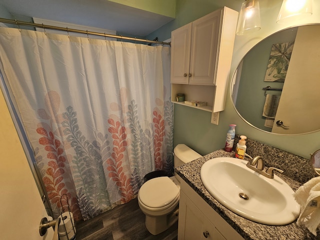 full bath with vanity, curtained shower, toilet, and wood finished floors