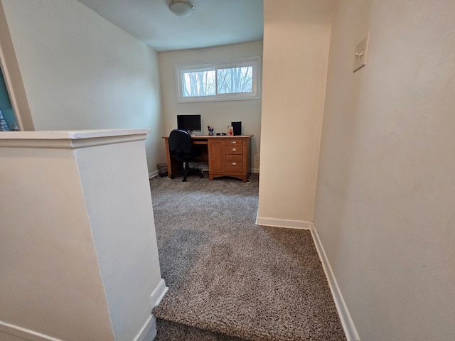 carpeted home office with baseboards