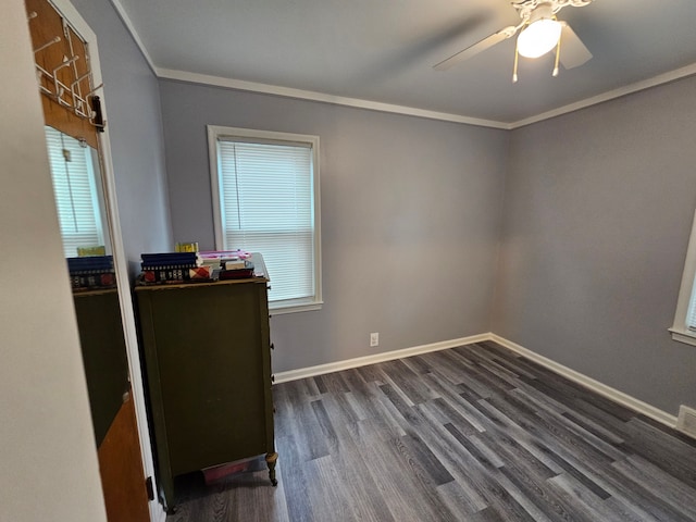 interior space featuring baseboards, ceiling fan, ornamental molding, and dark wood-style floors