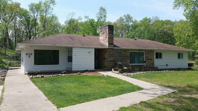 ranch-style home featuring a chimney, a shingled roof, and a front lawn